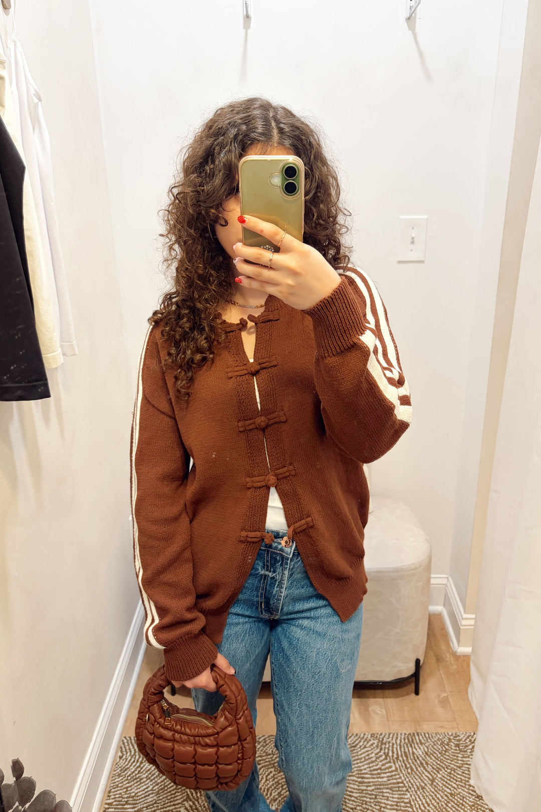 Stanton Dazed white Stripe brown Cardigan long sleeve ribbed knit long length with denim jeans and a brown quilted puffy bag.