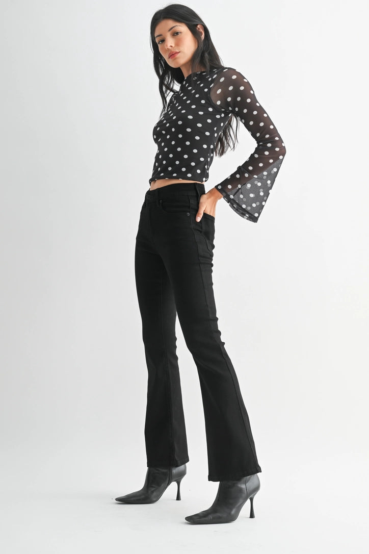 just black denim just USA brand mid rise boot cut black jeans with black leather booties and a black and white polka dot long sleeve top