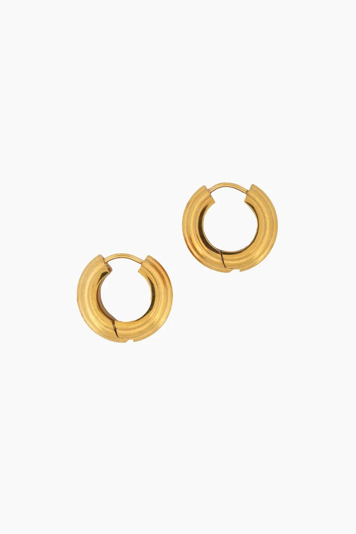 A pair of gold-toned segmented hoop earrings on a plain white background. may martin 14k gold-dipped cassidy hoop earrings
