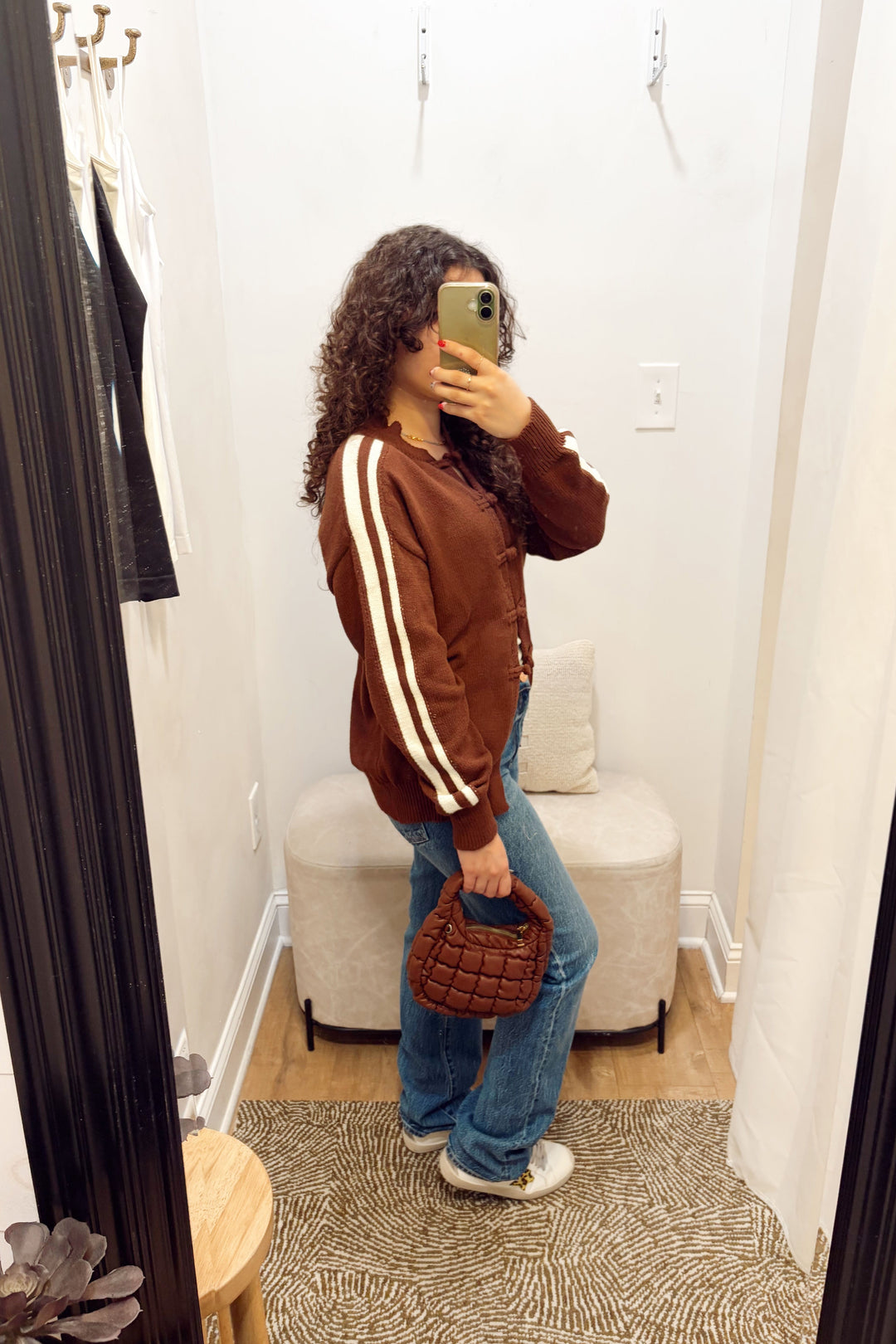 Stanton Dazed white Stripe brown Cardigan long sleeve ribbed knit long length with denim jeans and a brown quilted puffy bag.