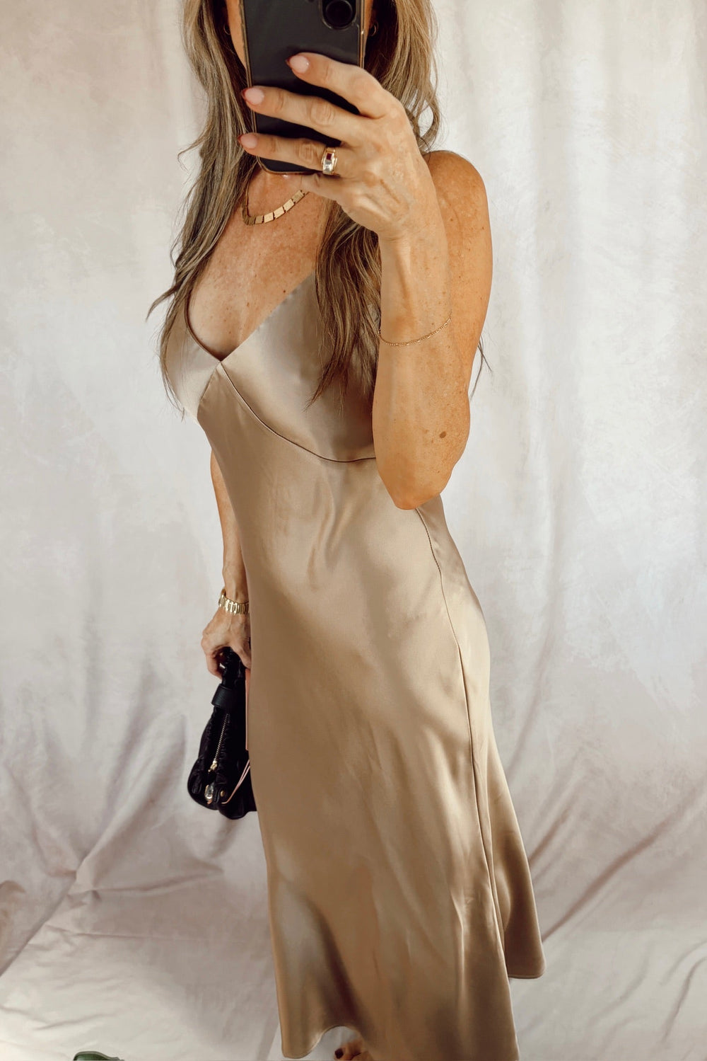 Stanton Mika satin maxi length slip dress light taupe with a black clutch 