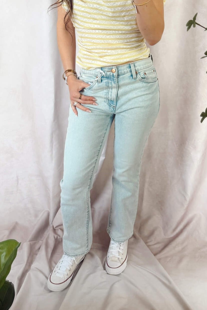 light wash pistola lennon high rise crop boot cut jeans cherish with converse sneakers and free people Ellie top Sicilian combo yellow and white stripe 