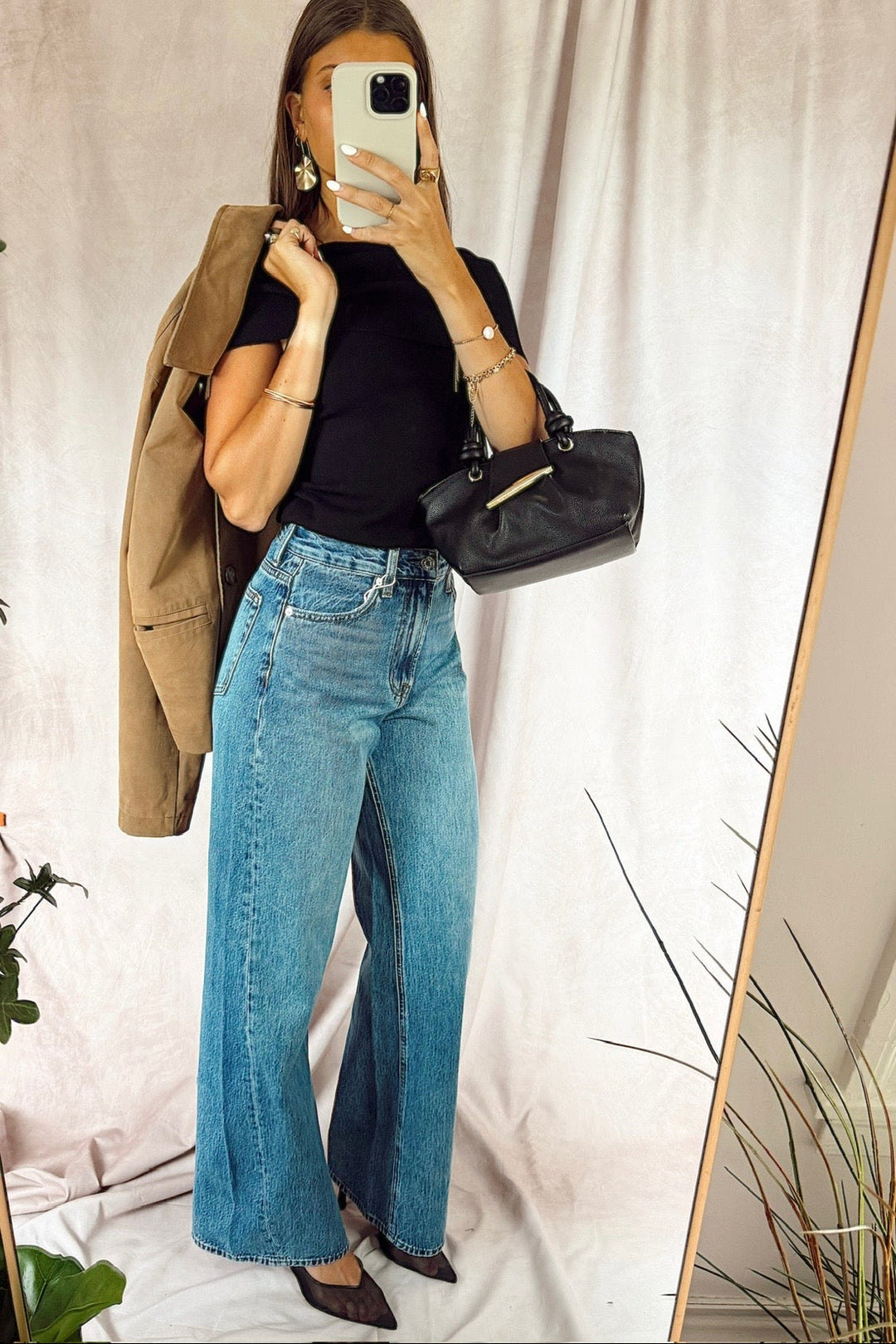 z supply The Head turner high rise wide leg denim jeans medium dark wash with a black off the shoulder top and a black handbag with a suede jacket over the shoulder from free people and black heels