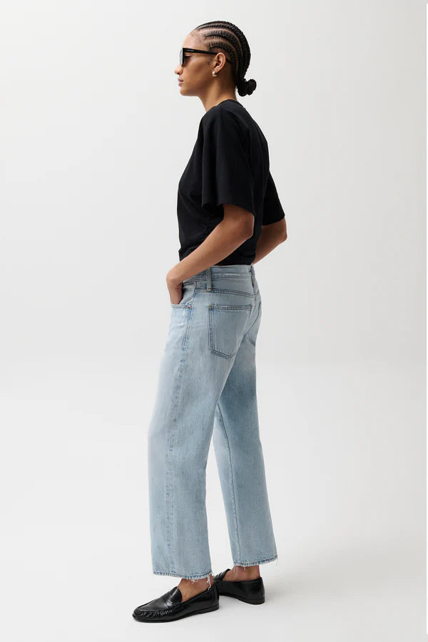 pistola lexi mid rise bowed straight leg jeans in a light wash with a black t-shirt and black slip-on shoes