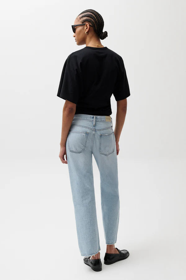 pistola lexi mid rise bowed straight leg jeans in a light wash with a black t-shirt and black slip-on shoes