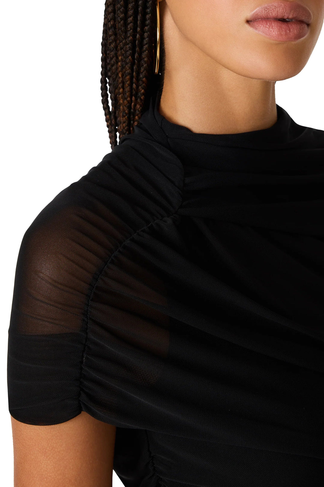  black short-sleeve top with sheer mesh ruching  and a ruched draped neckline, paired with black bottoms and black flats
