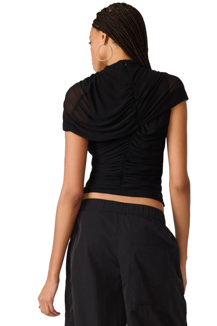  black short-sleeve top with sheer mesh ruching  and a ruched draped neckline, paired with black bottoms and black flats