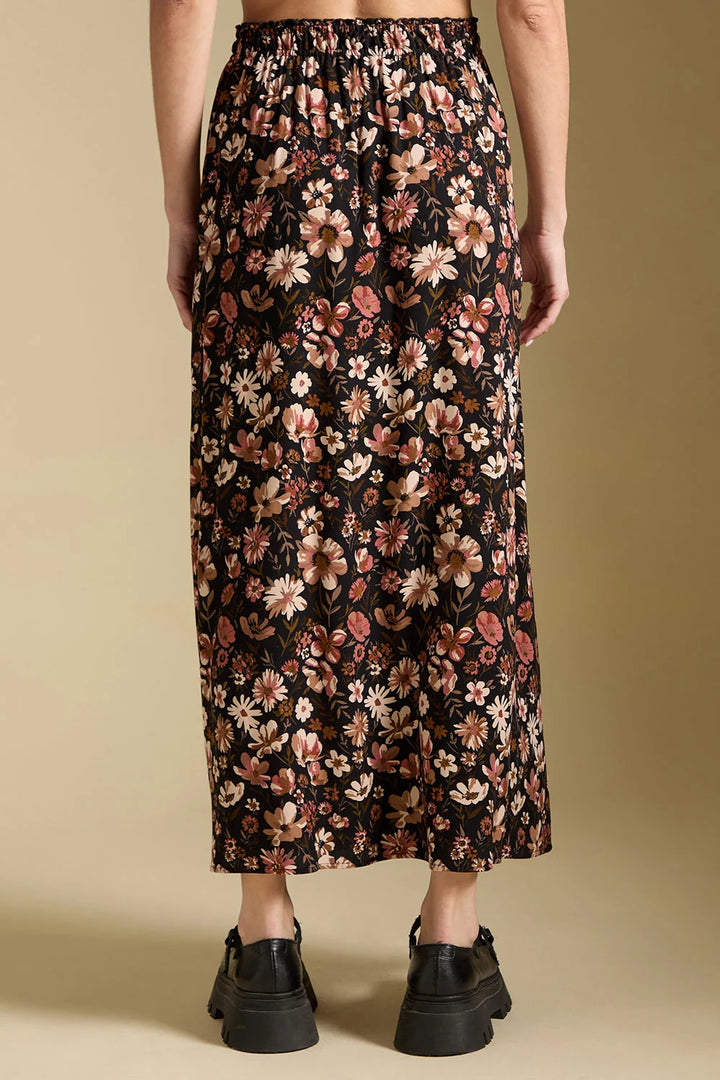 saltwater Luxe Ida midi skirt black with pink, off-white, and taupe floral print