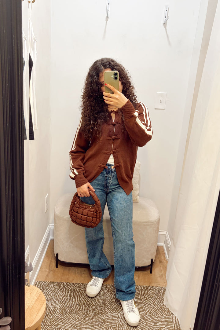Stanton Dazed white Stripe brown Cardigan long sleeve ribbed knit long length with denim jeans and a brown quilted puffy bag.
