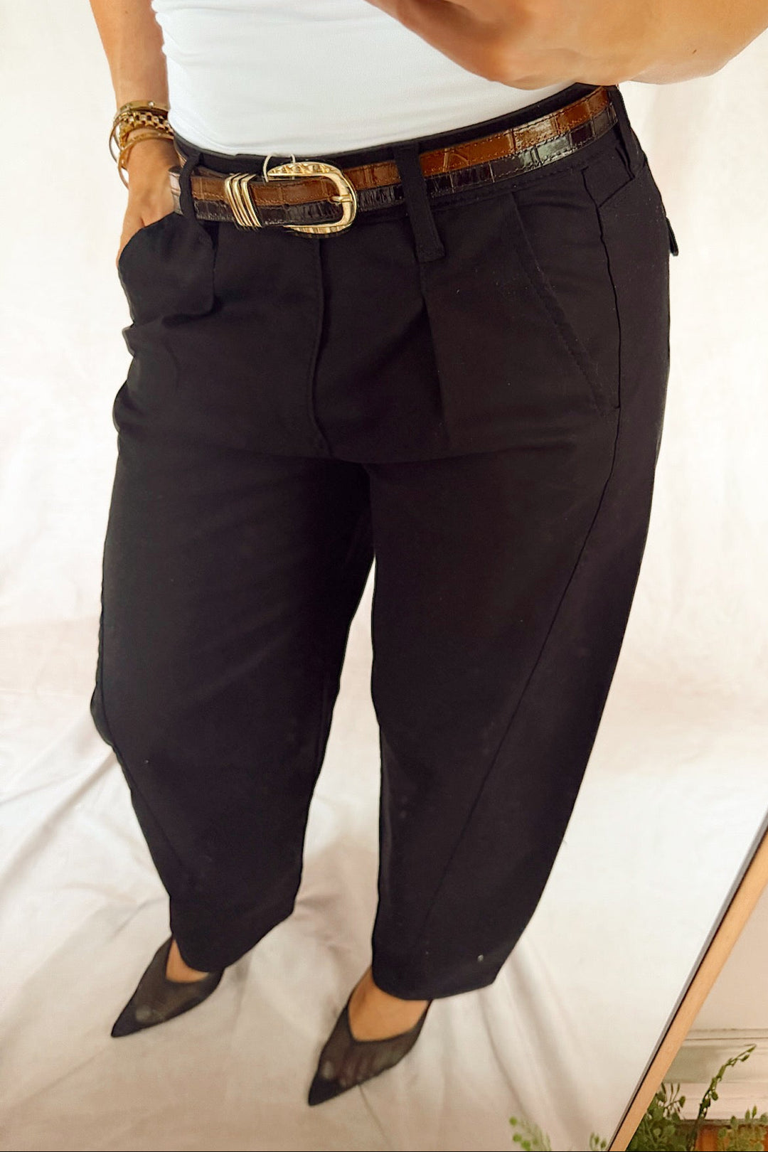 bevy Flog high rise pleated tapered trouser with a smooth white tank top and black heels and a two-tone leather croc glazed belt 