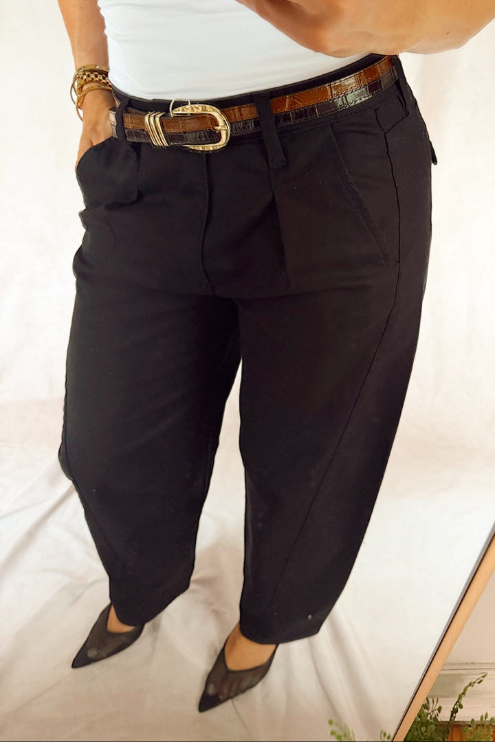 bevy Flog high rise pleated tapered trouser with a smooth white tank top and black heels and a two-tone leather croc glazed belt 