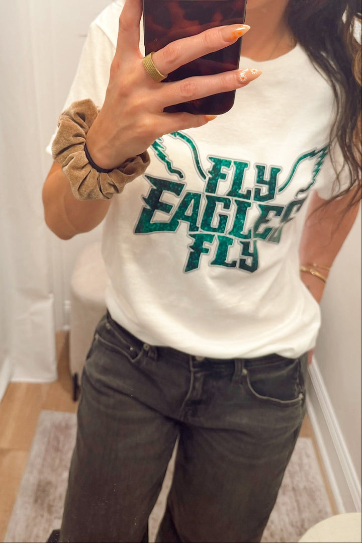 short sleeve crew neck T-shirt with "fly eagles fly" lettering in a glitter print Philadelphia eagles football gear merch apparel for women in south jersey