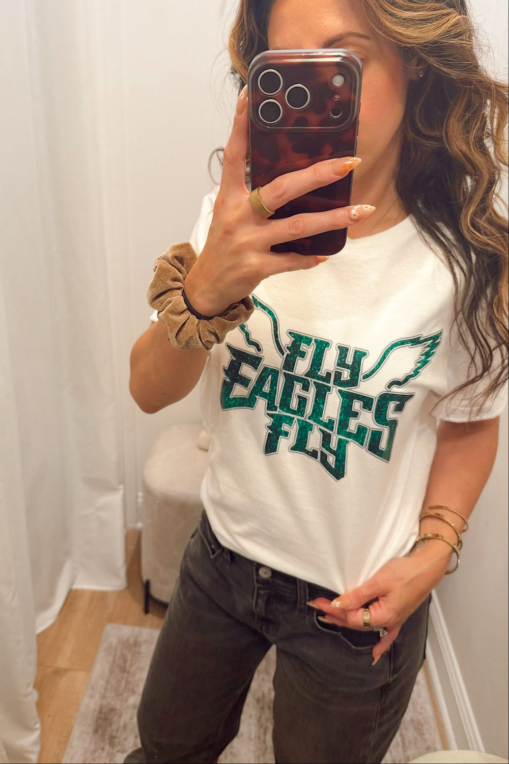 short sleeve crew neck T-shirt with "fly eagles fly" lettering in a glitter print Philadelphia eagles football gear merch apparel for women in south jersey
