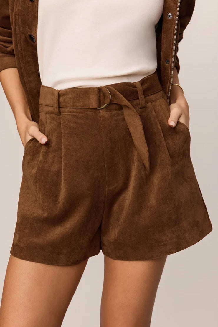 z Supply ivory suede shorts brown with matching suede belt and jacket layered over a cream colored top paired with tall black boots