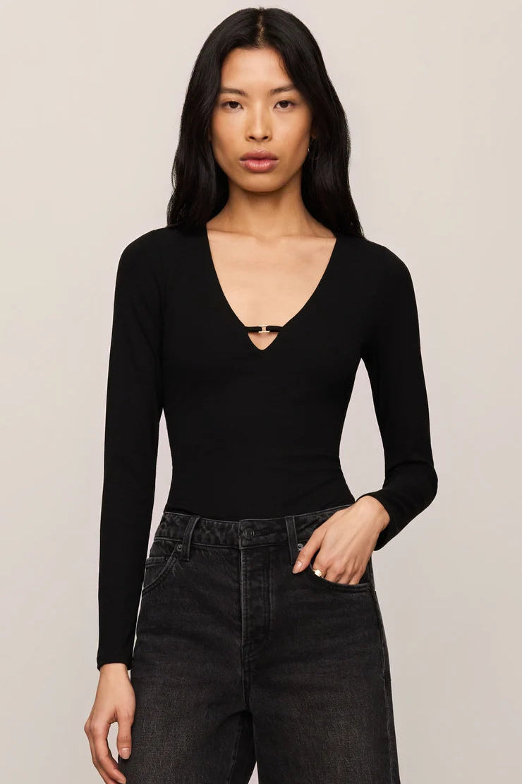 z Supply Ginger Long sleeve ribbed black v-neck thong bodysuit with gold hardware detail paired with washed black denim
