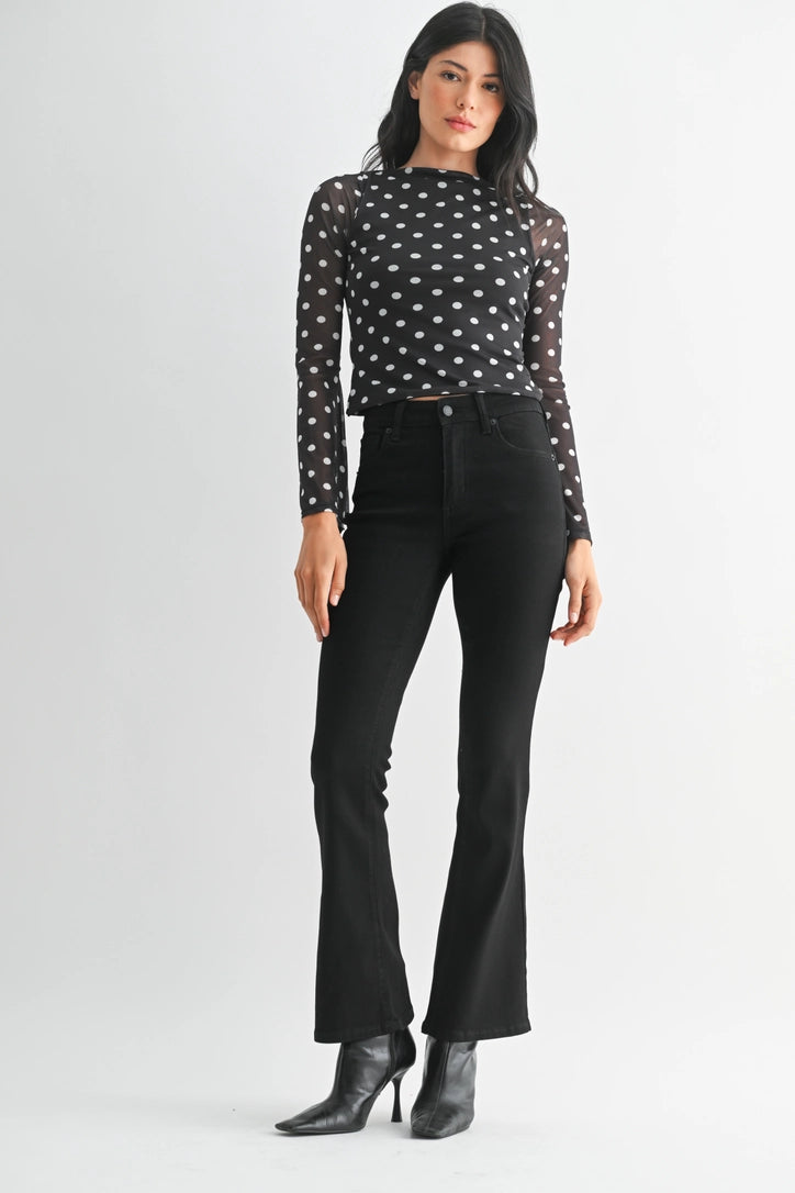 just black denim just USA brand mid rise boot cut black jeans with black leather booties and a black and white polka dot long sleeve top