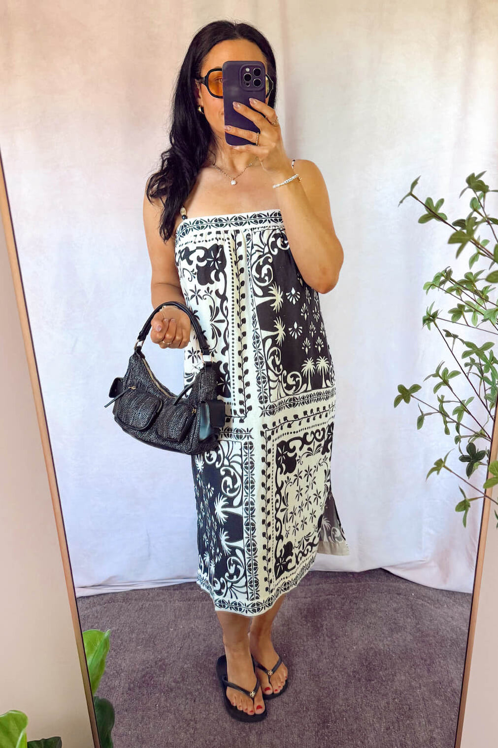 bella dahl Sleeveless spaghetti strap wooden beads midi dress black and white patterns with black woven handbag and black sandals 