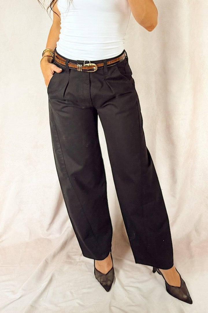 bevy Flog high rise pleated tapered trouser with a smooth white tank top and black heels and a two-tone leather croc glazed belt 