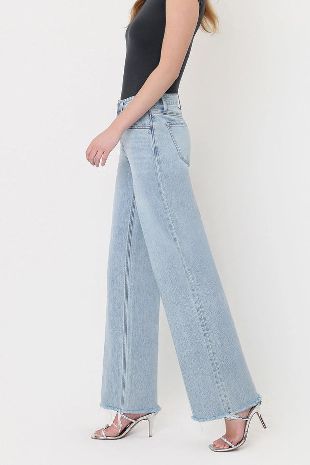 vervet Olivia High rise wide leg trouser crease seam frayed raw hem with black tank and silver strappy kitten heel sandals