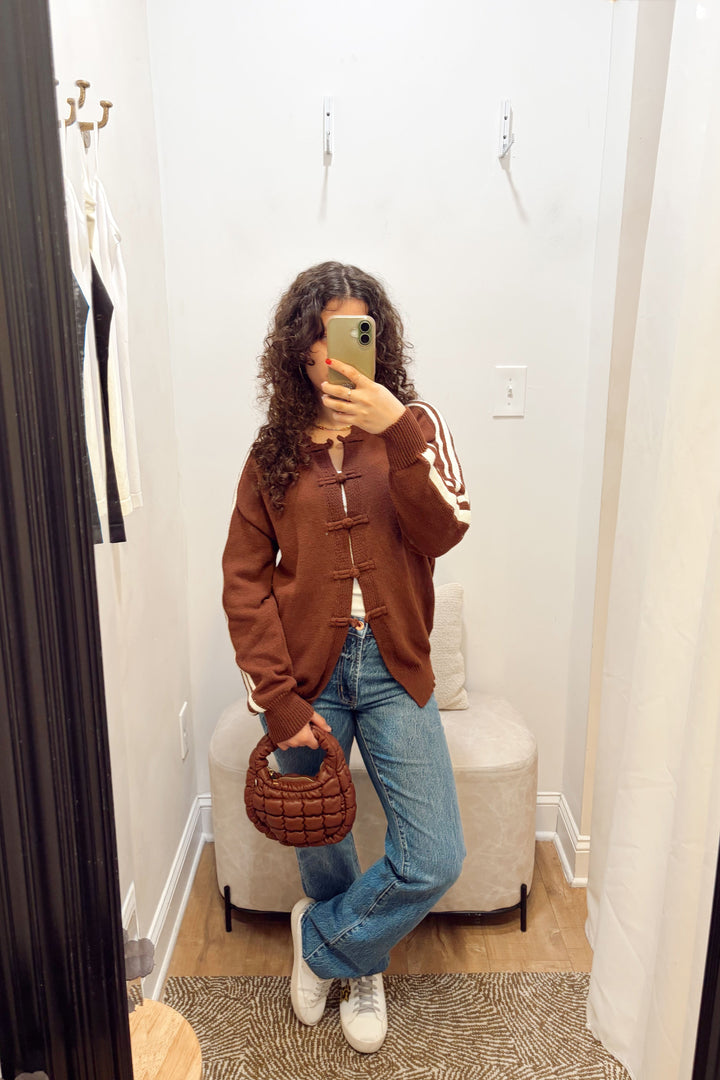 Stanton Dazed white Stripe brown Cardigan long sleeve ribbed knit long length with denim jeans and a brown quilted puffy bag.
