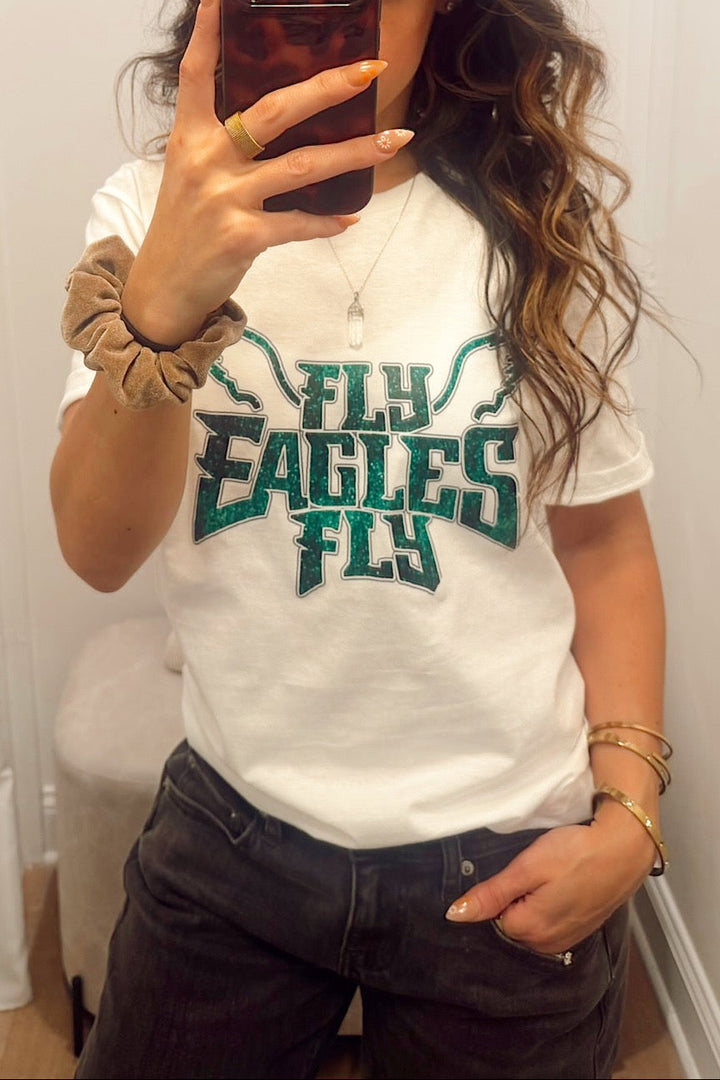 short sleeve crew neck T-shirt with "fly eagles fly" lettering in a glitter print Philadelphia eagles football gear merch apparel for women in south jersey