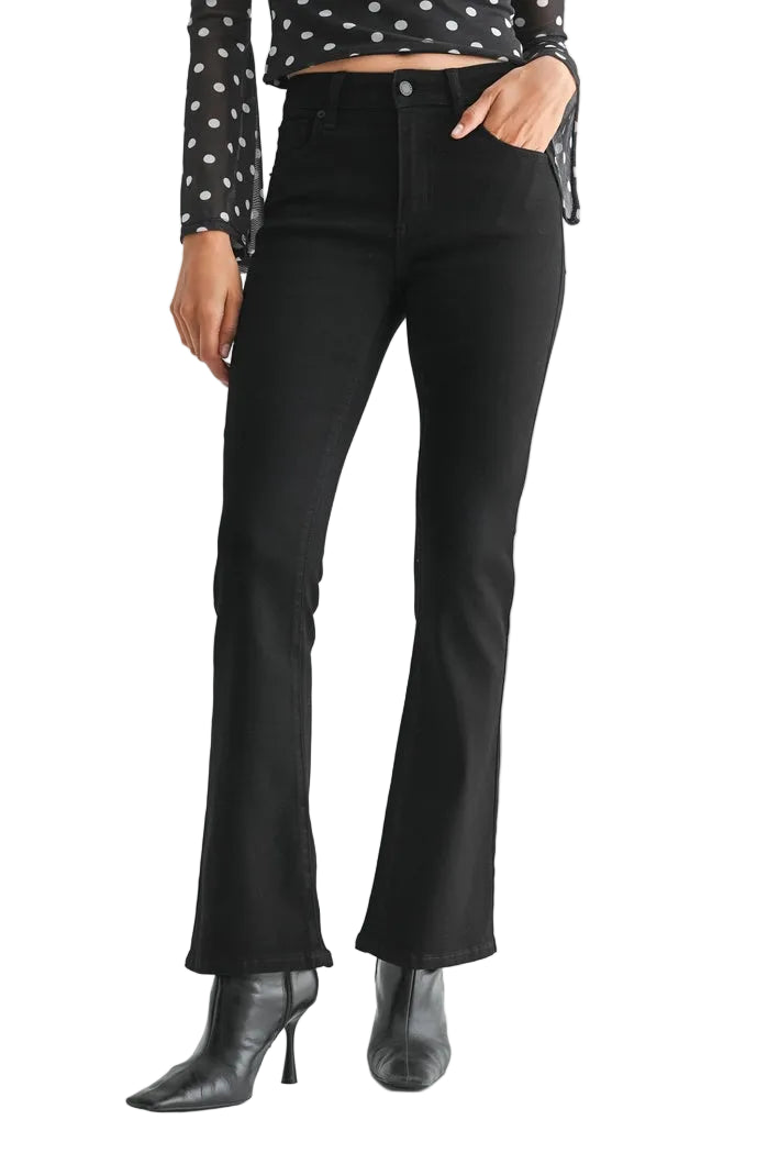 just black denim just USA brand mid rise boot cut black jeans with black leather booties and a black and white polka dot long sleeve top