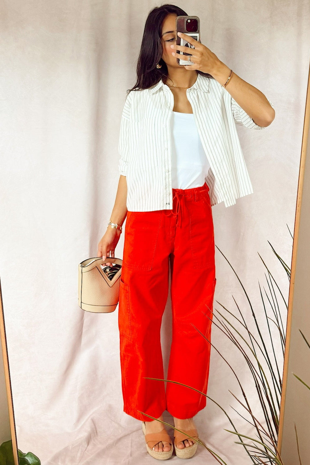 red PISTOLA Sabrina curved Utility pants with a z supply favorite striped button up layered over a white smooth cami 