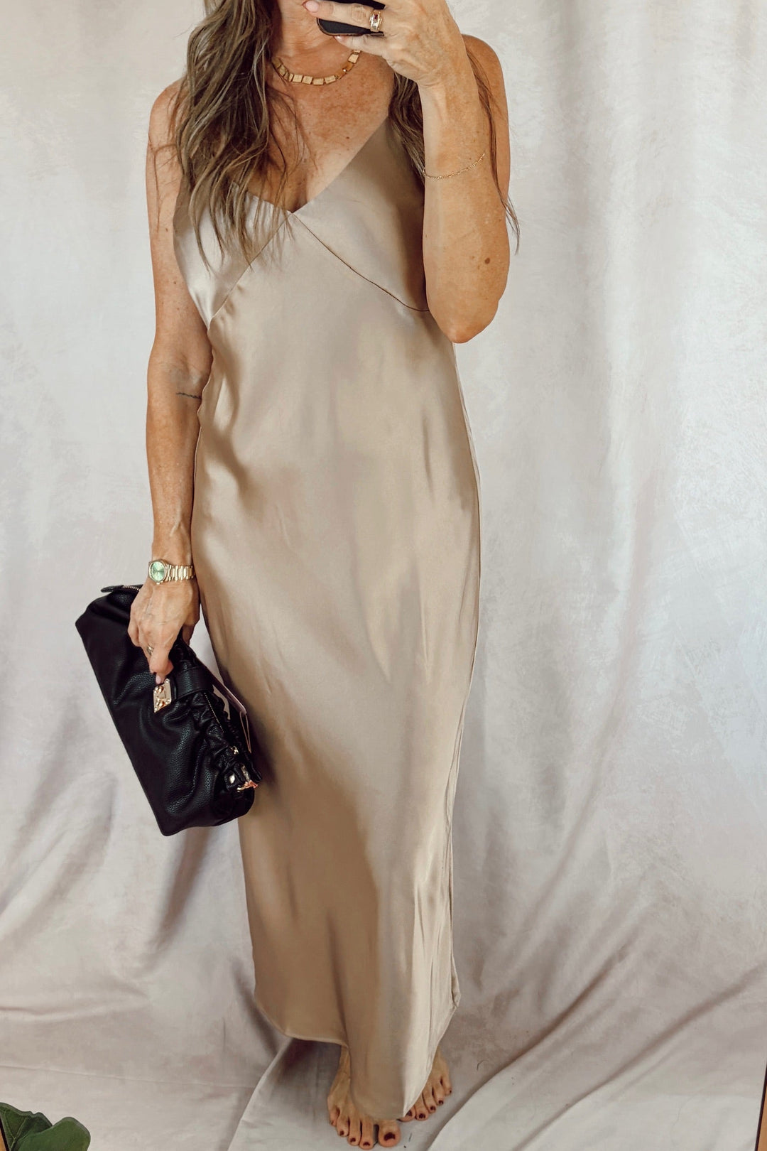 Stanton Mika satin maxi length slip dress light taupe with a black clutch 