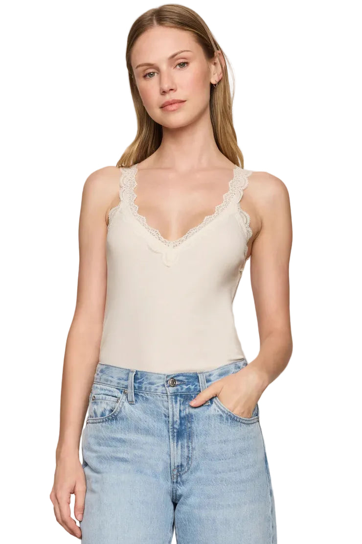 z supply eve off white sand stone lace tank top and blue jeans against a plain background